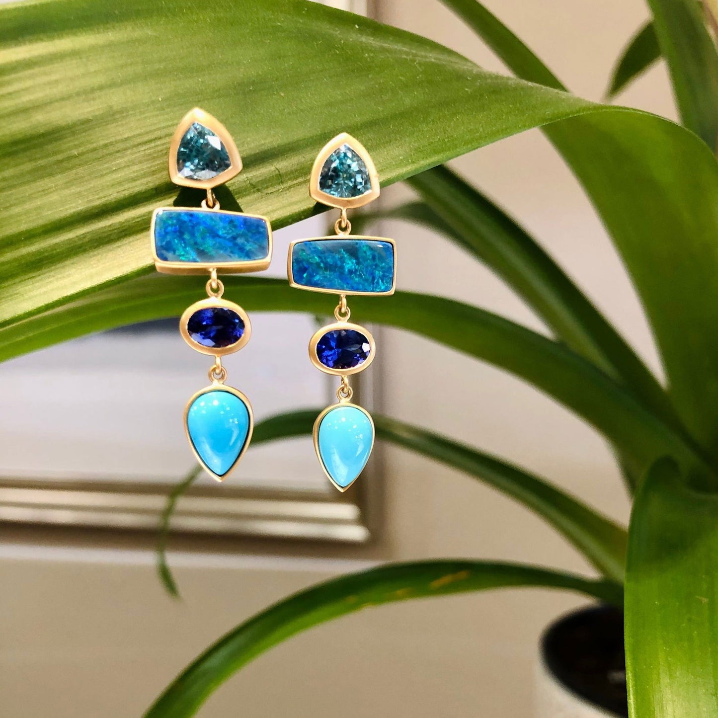 Photo of Blue Dream Drop-Dangles in a decorative scene, designed by , available at Plumb Gold & Plumb Silver