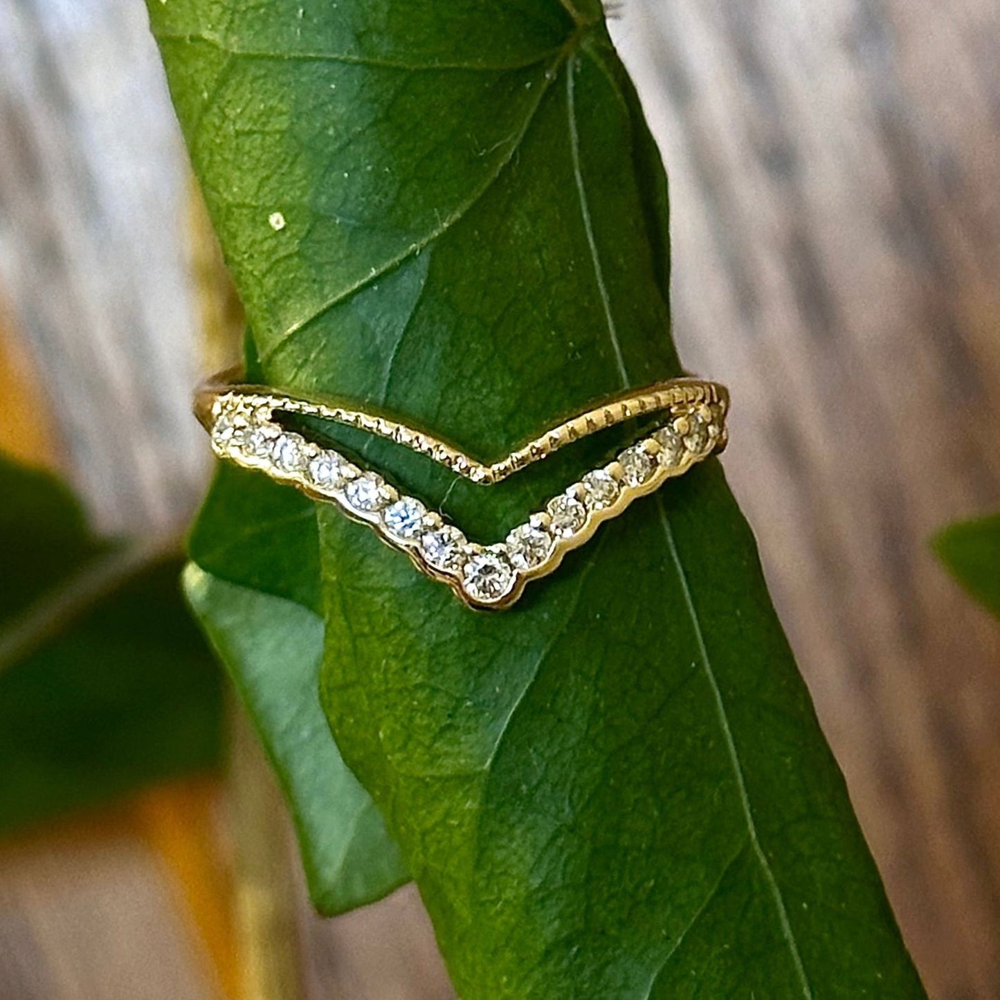 Photo of Double Chevron Stackable Ring in a decorative scene, designed by , available at Plumb Gold & Plumb Silver