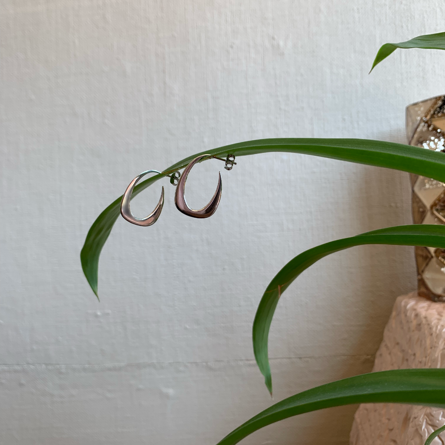 Photo of J Hoop Earrings in a decorative scene, designed by , available at Plumb Gold & Plumb Silver