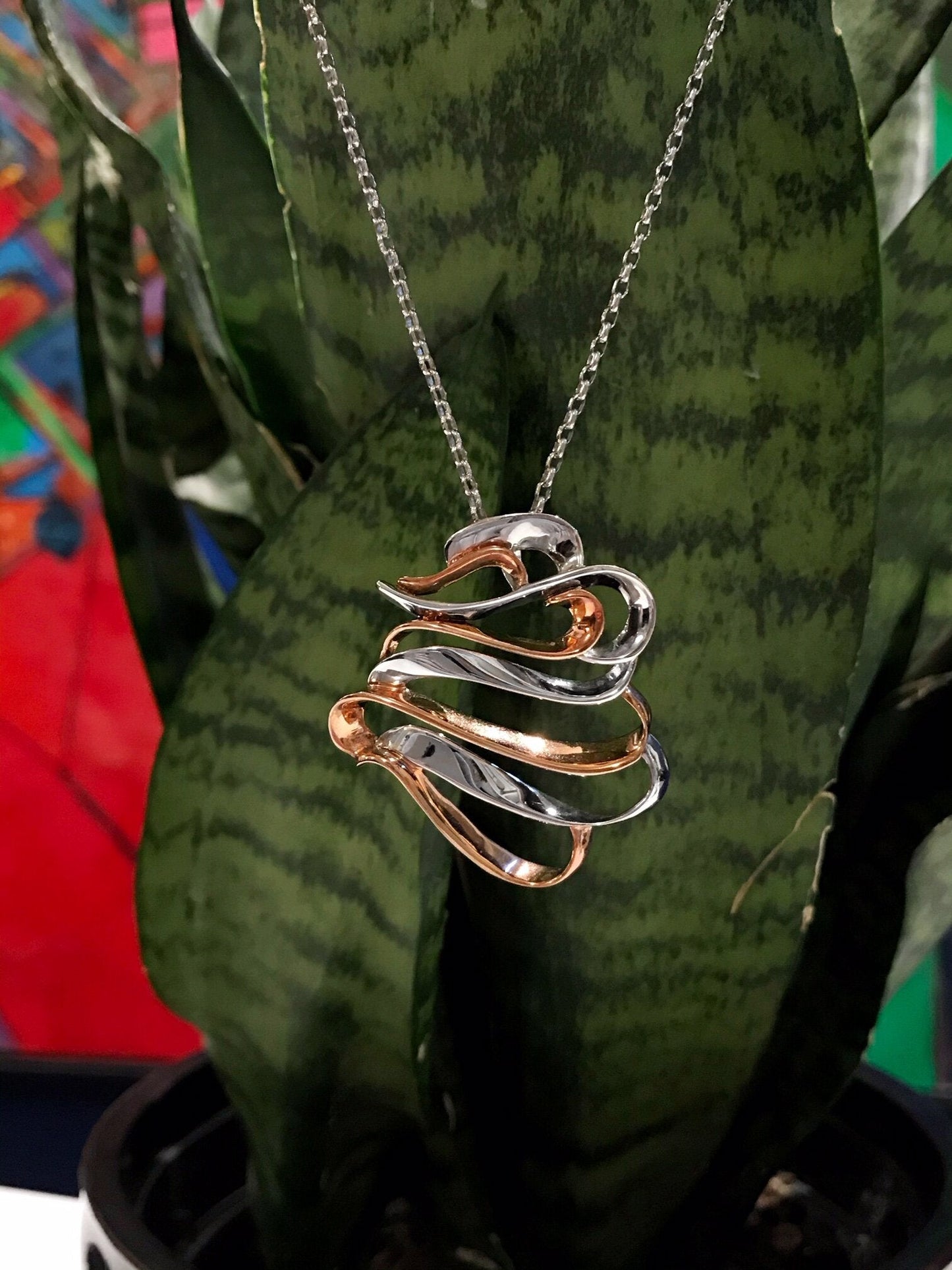 Photo of "Swan" Pendant in a decorative scene, designed by , available at Plumb Gold & Plumb Silver