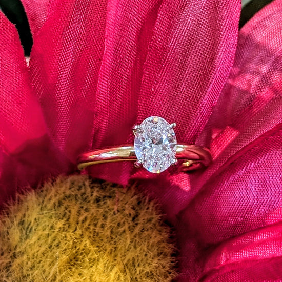 Photo of 0.90ct Oval Solitaire in a decorative scene, designed by , available at Plumb Gold & Plumb Silver