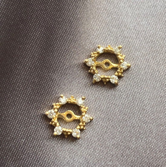 Photo of 14KY Star Diamond Earring Jackets in a decorative scene, designed by , available at Plumb Gold & Plumb Silver