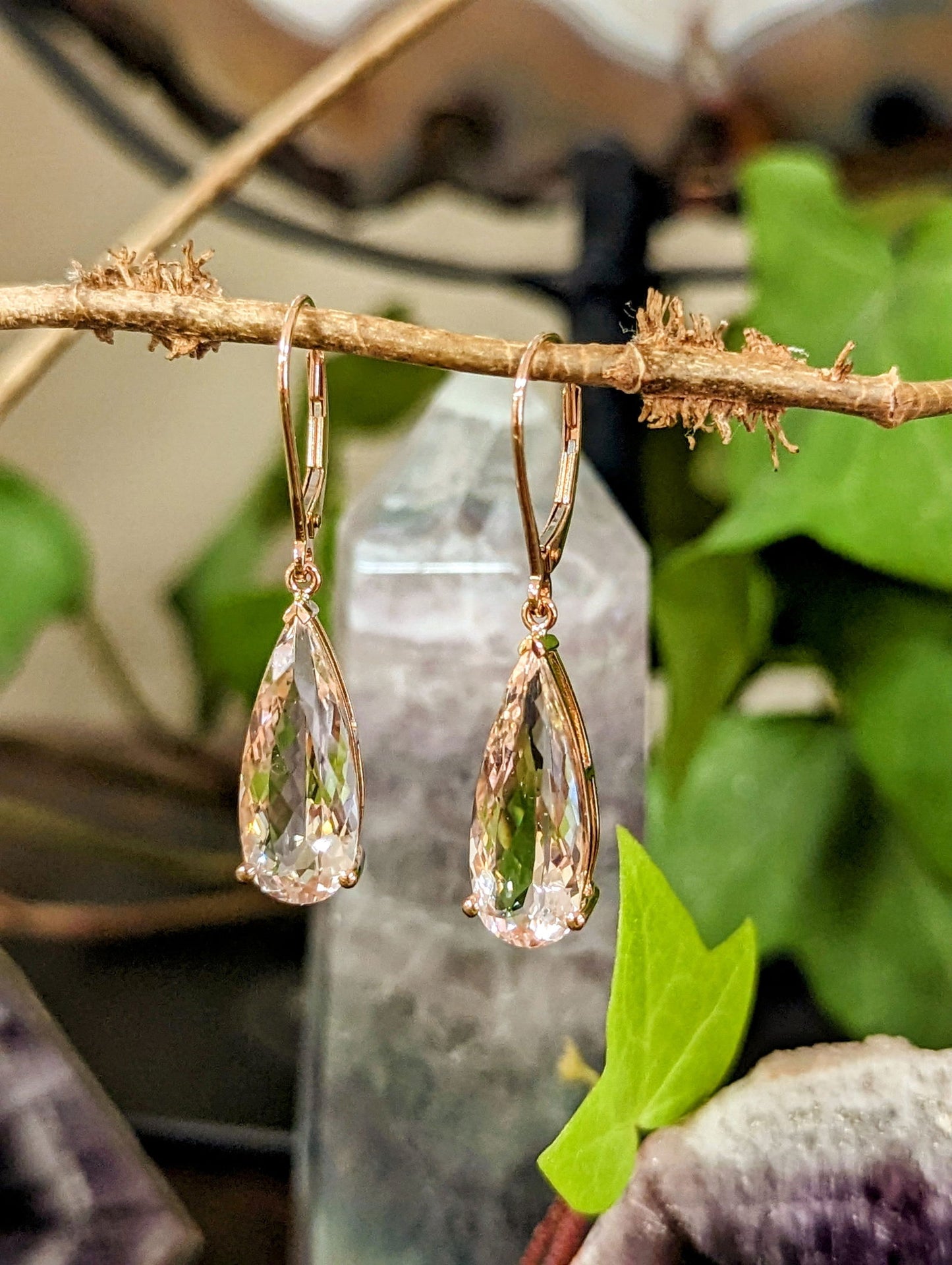 Photo of 9.61ctw Morganite Dangle Earrings in a decorative scene, designed by , available at Plumb Gold & Plumb Silver