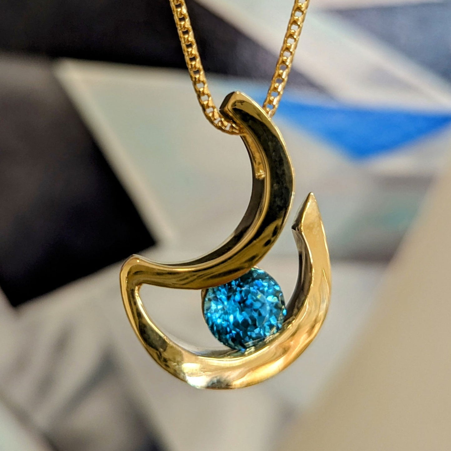 Photo of "Alee" Pendant in a decorative scene, designed by , available at Plumb Gold & Plumb Silver