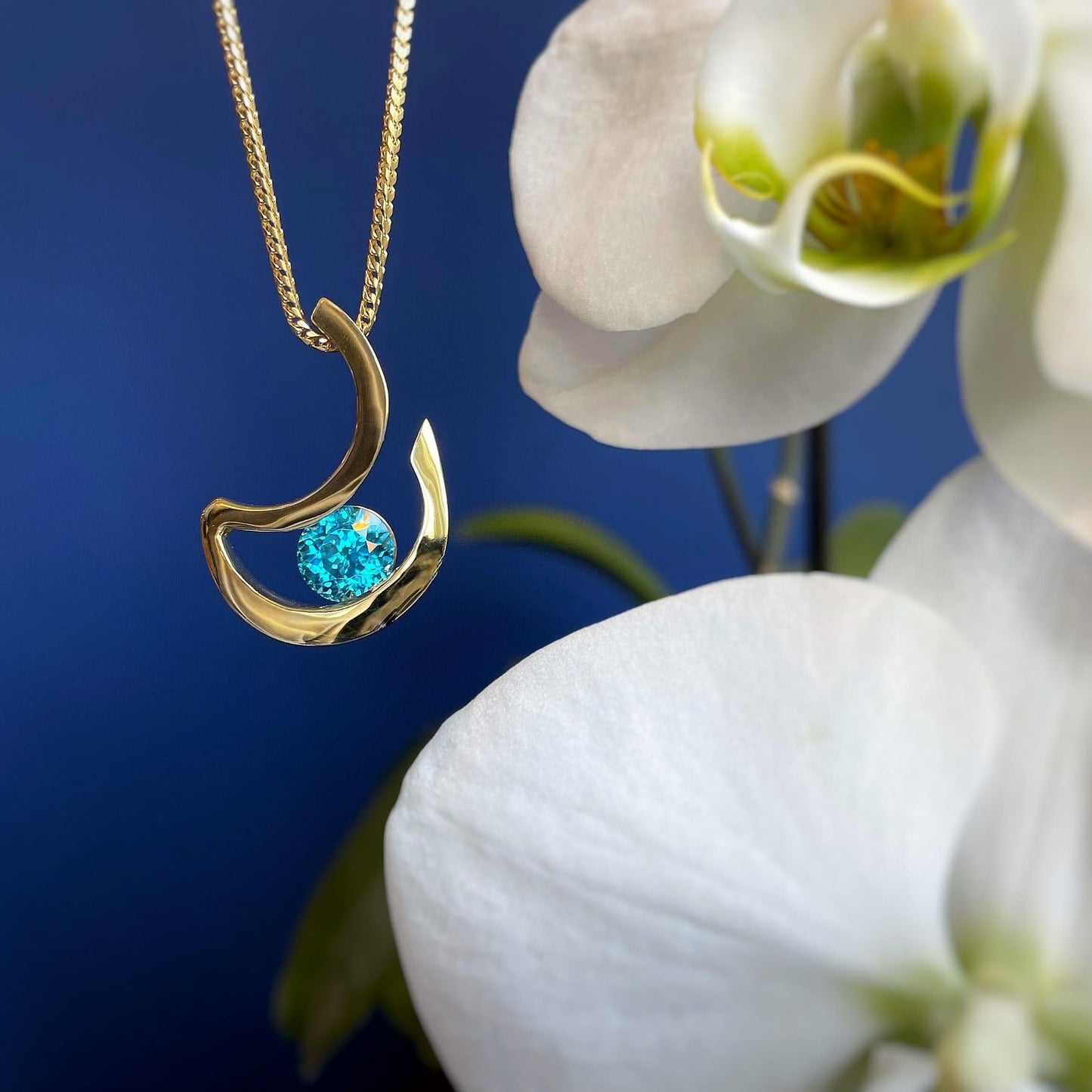 Photo of "Alee" Pendant in a decorative scene, designed by , available at Plumb Gold & Plumb Silver