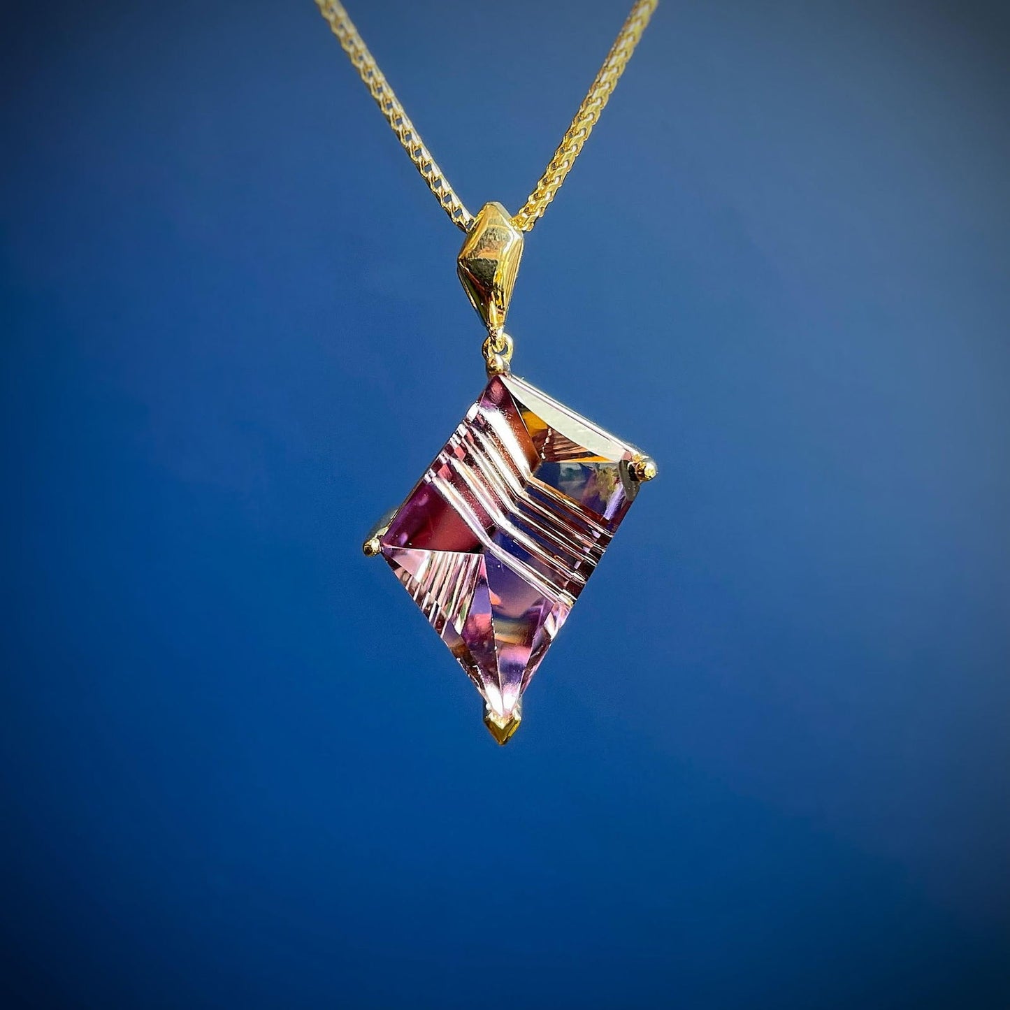 Photo of Ametrine Pendant in a decorative scene, designed by , available at Plumb Gold & Plumb Silver