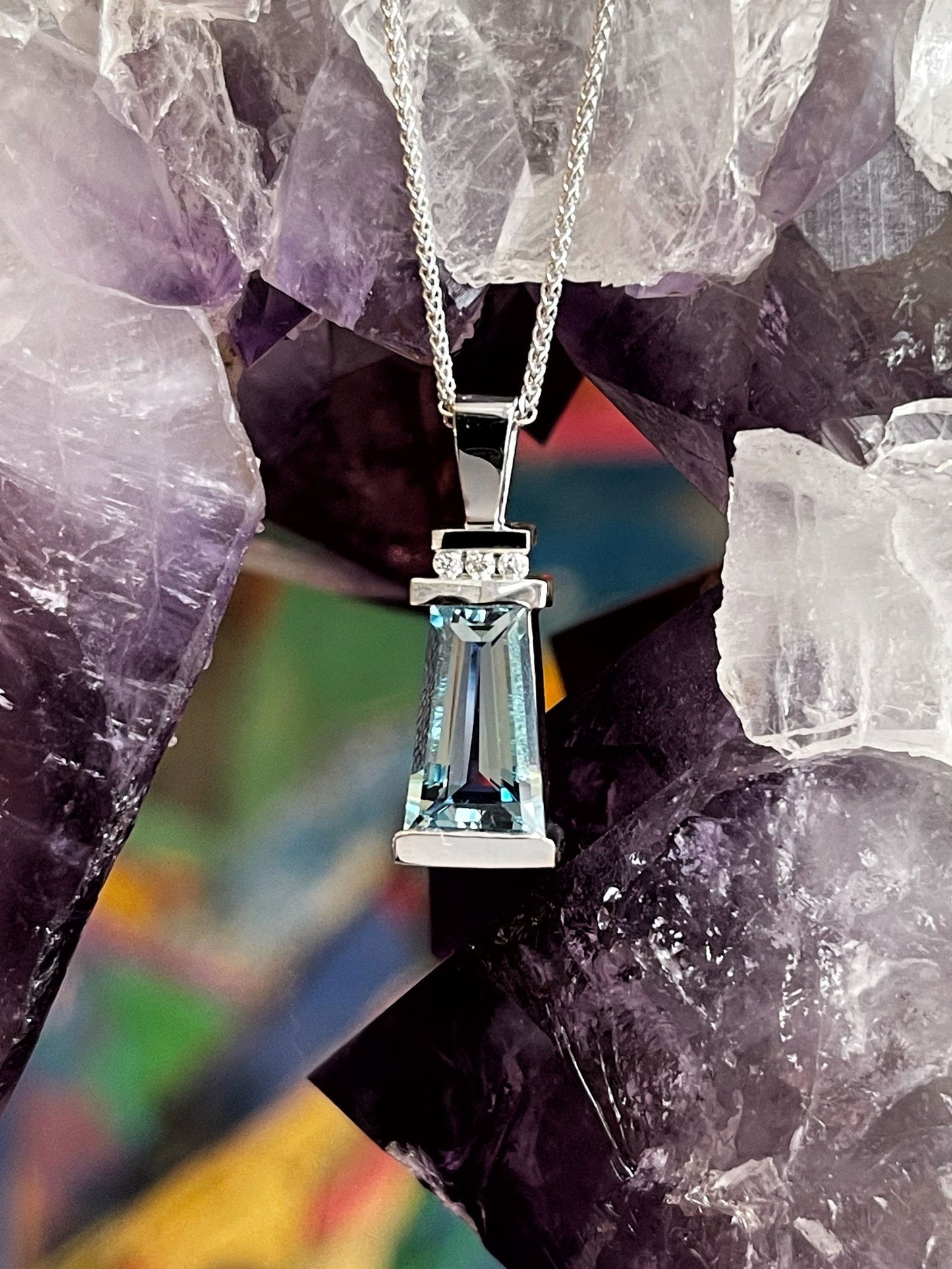 Photo of Aquamarine Pendant in a decorative scene, designed by , available at Plumb Gold & Plumb Silver