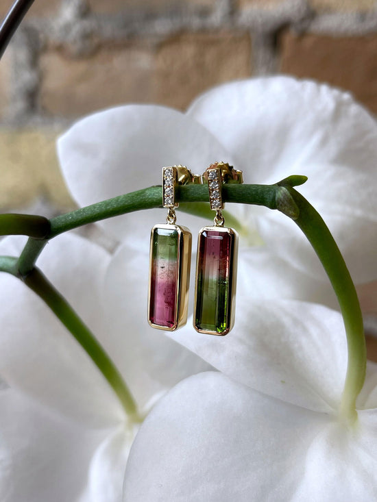 Photo of Asymmetrical Watermelon Tourmaline Dangles in a decorative scene, designed by , available at Plumb Gold & Plumb Silver
