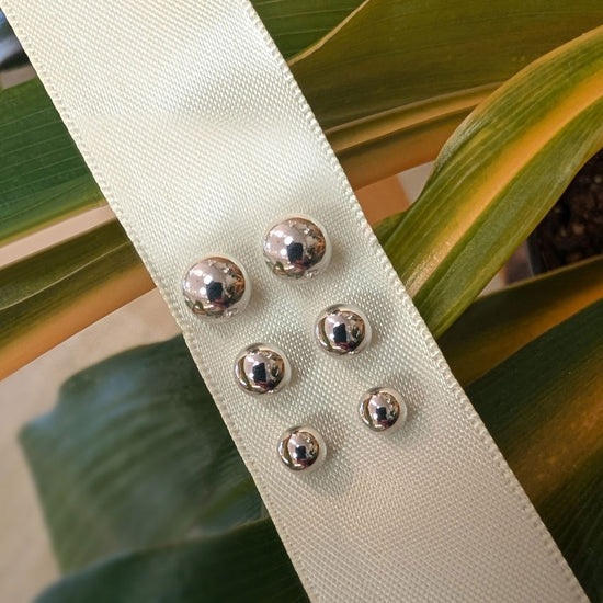 Photo of Ball Post Earrings in a decorative scene, designed by , available at Plumb Gold & Plumb Silver