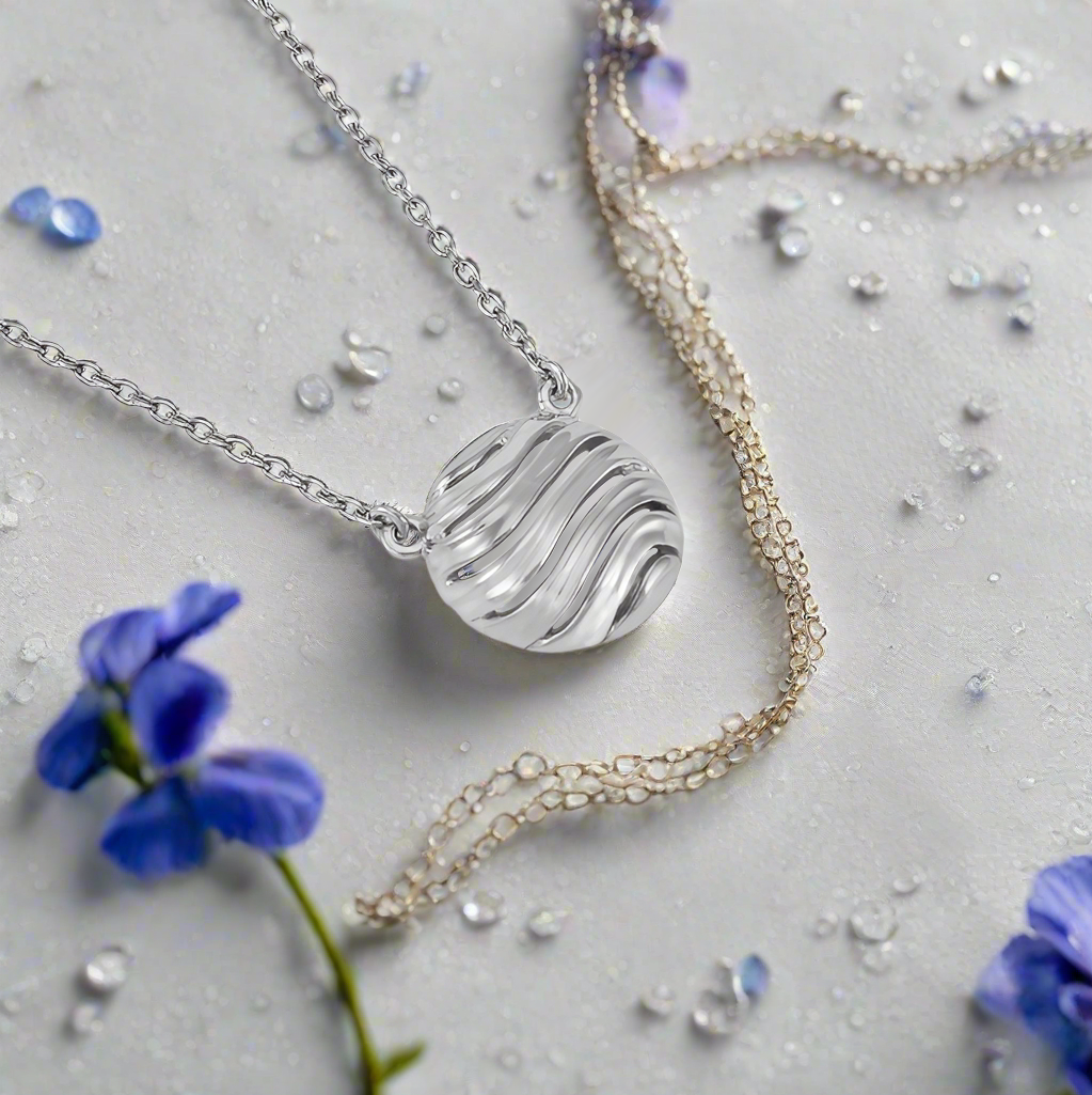 Photo of "Bay" Necklace in a decorative scene, designed by , available at Plumb Gold & Plumb Silver