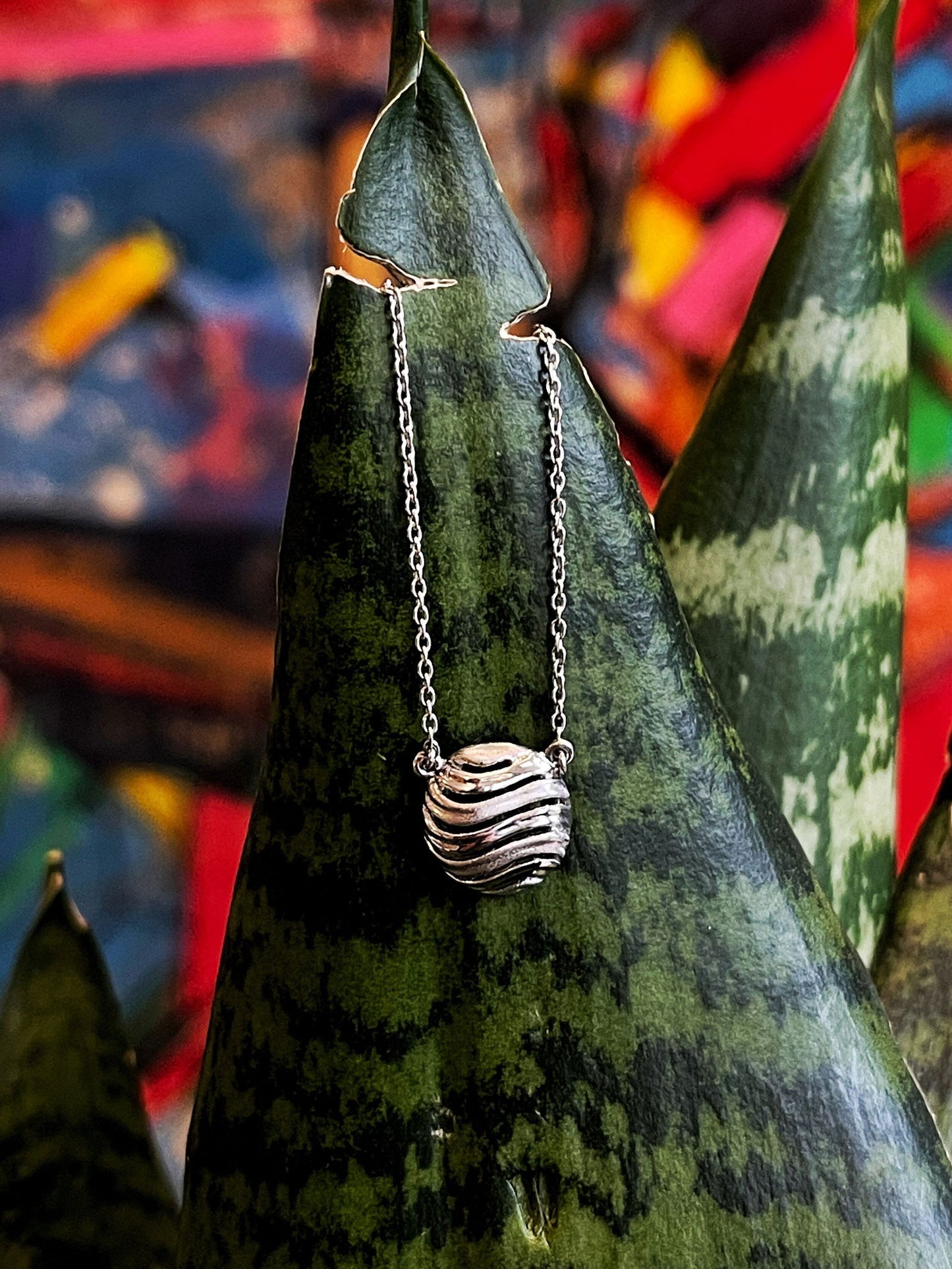 Photo of "Bay" Necklace in a decorative scene, designed by , available at Plumb Gold & Plumb Silver