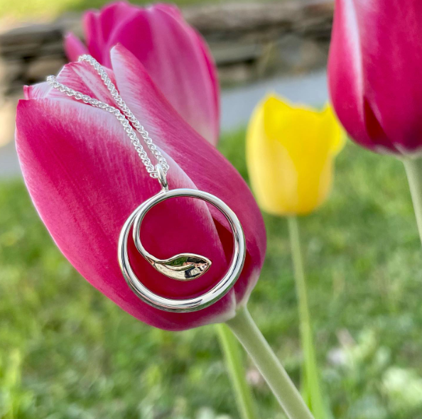 Photo of "Be-Leaf" Necklace in a decorative scene, designed by , available at Plumb Gold & Plumb Silver
