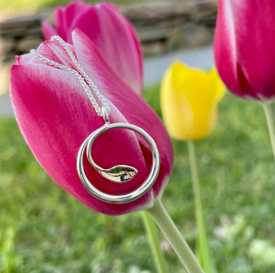 Photo of "Be-Leaf" Necklace in a decorative scene, designed by , available at Plumb Gold & Plumb Silver