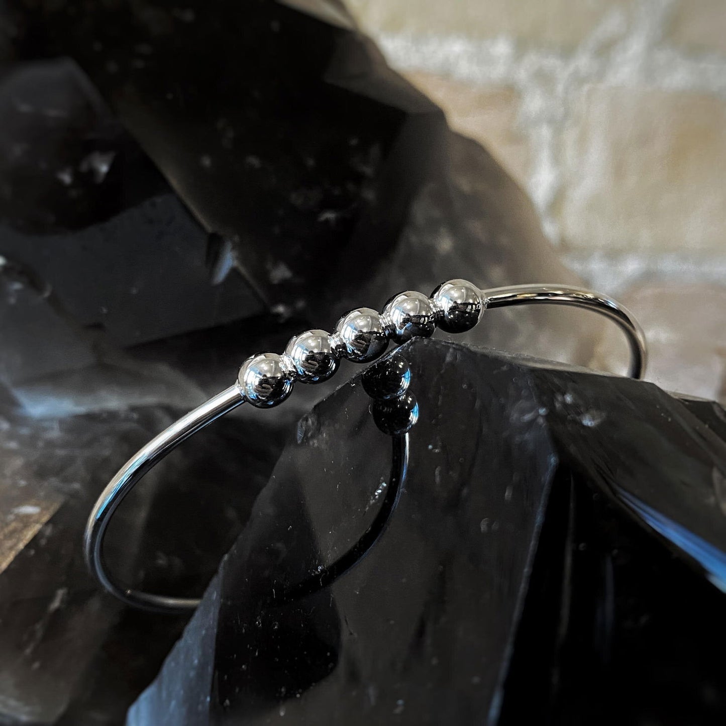 Photo of Beaded Cuff Bracelet in a decorative scene, designed by , available at Plumb Gold & Plumb Silver