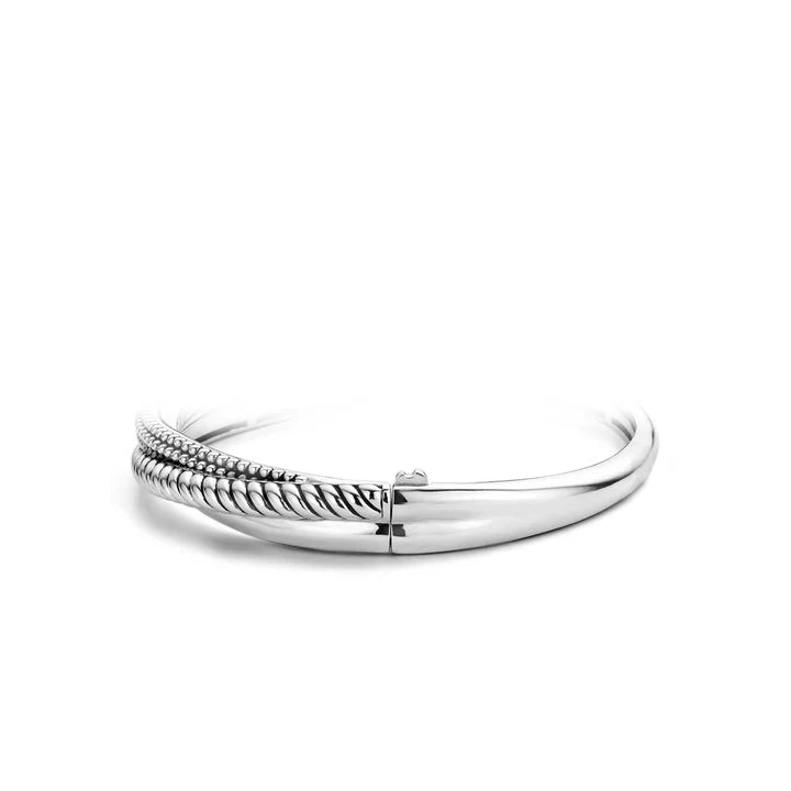 Photo of Beaded Rope Bangle in a decorative scene, designed by , available at Plumb Gold & Plumb Silver
