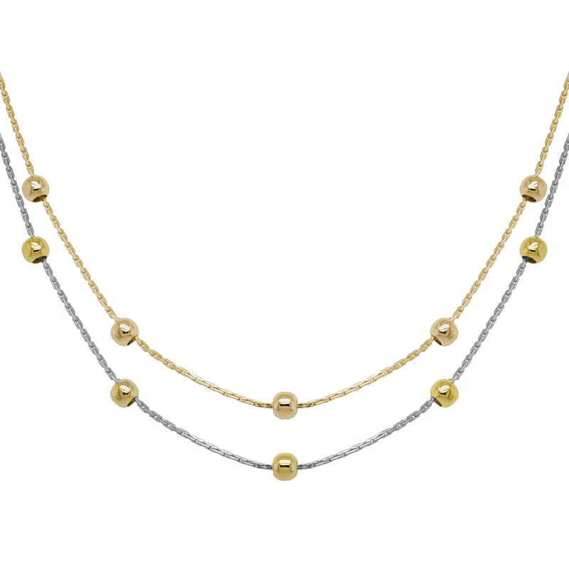 Photo of Beaded Station Chain in a decorative scene, designed by , available at Plumb Gold & Plumb Silver