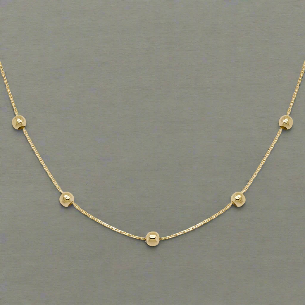 Photo of Beaded Station Chain in a decorative scene, designed by , available at Plumb Gold & Plumb Silver