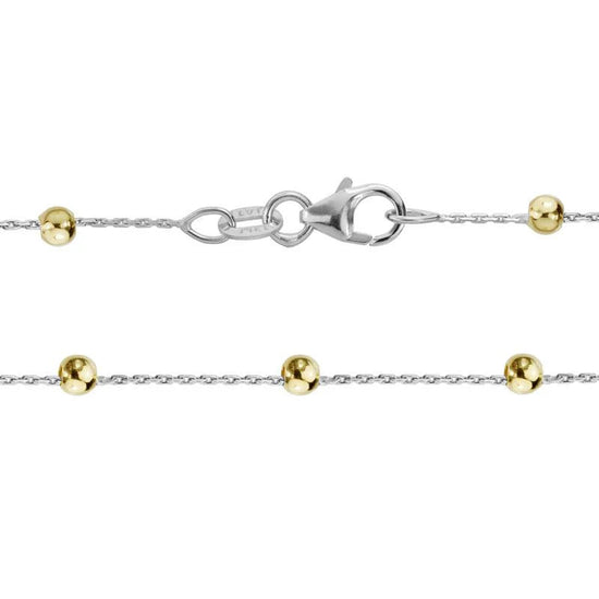 Photo of Beaded Station Chain in a decorative scene, designed by , available at Plumb Gold & Plumb Silver