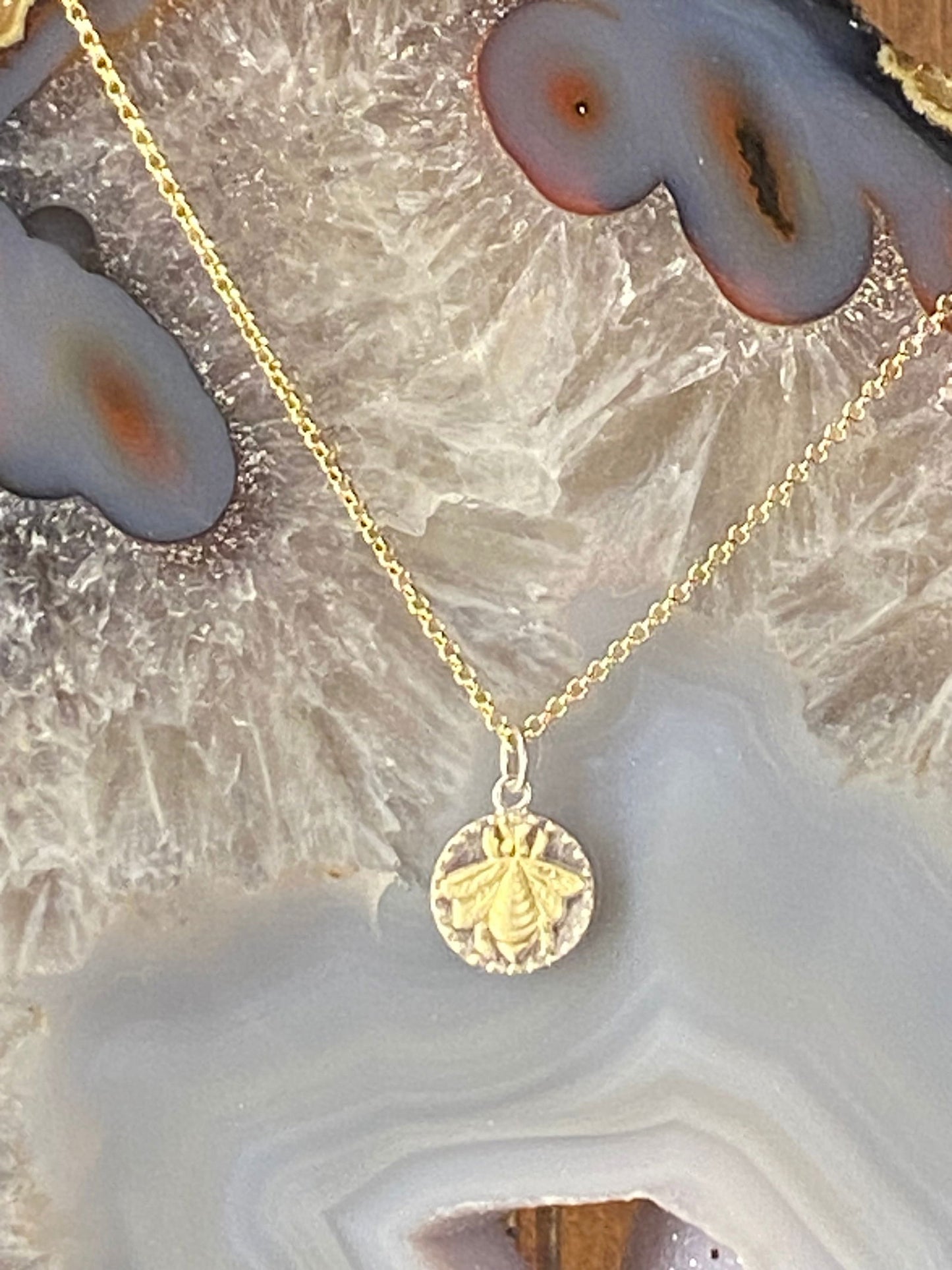 Photo of Bee Pendant or Charm in a decorative scene, designed by , available at Plumb Gold & Plumb Silver