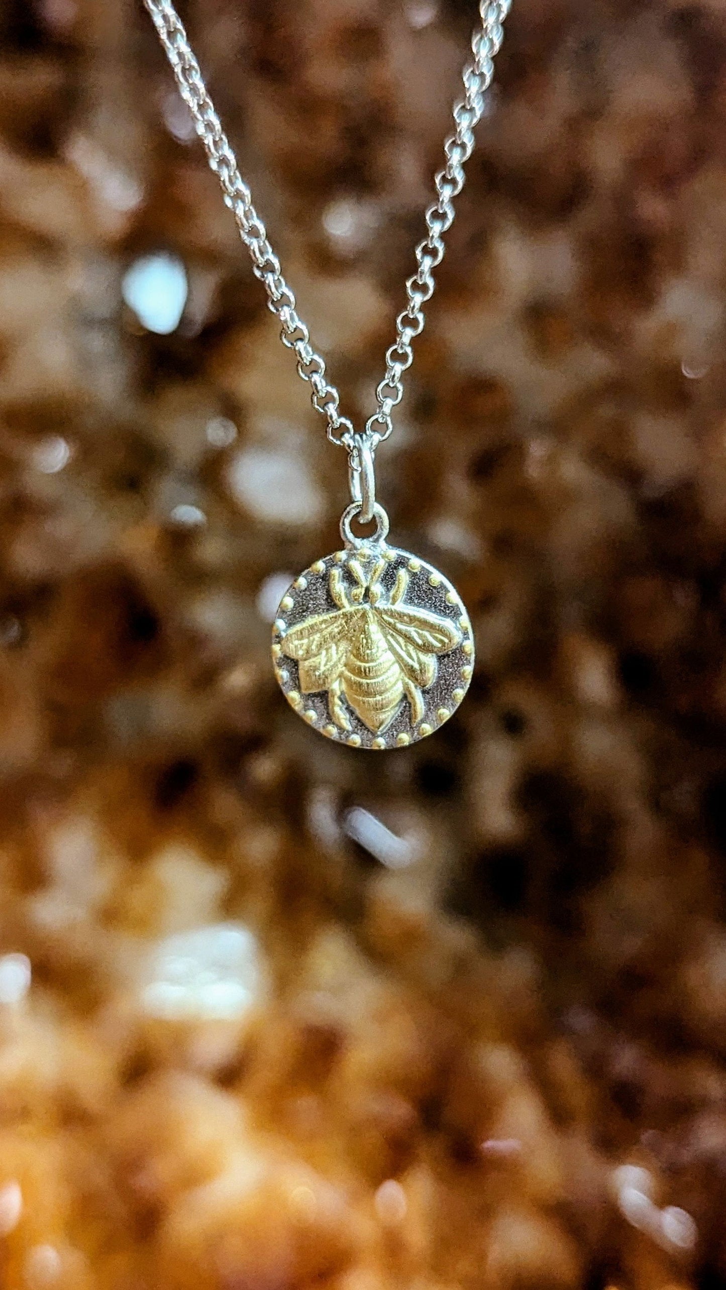 Photo of Bee Pendant or Charm in a decorative scene, designed by , available at Plumb Gold & Plumb Silver