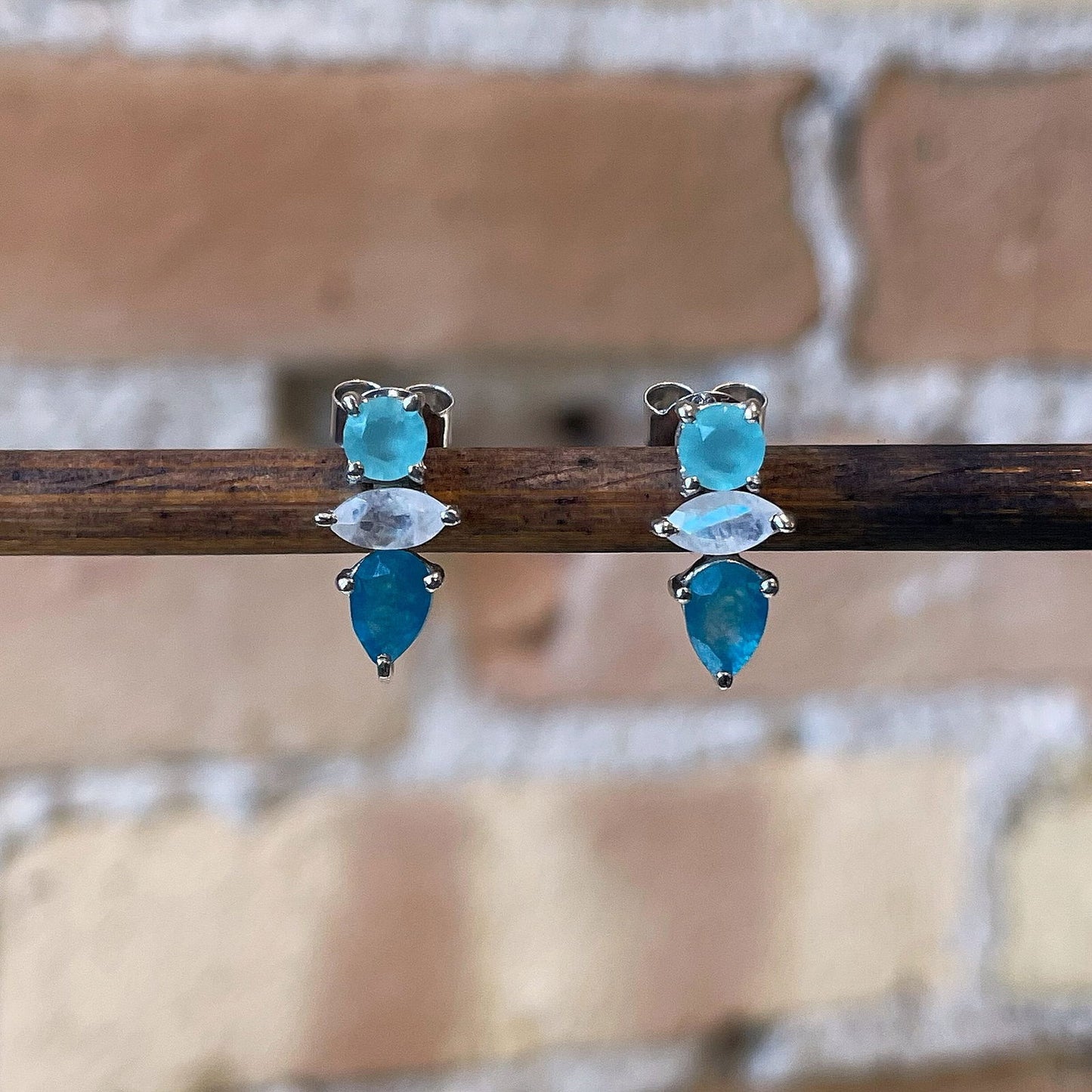 Photo of “Bella” Multi-Stone Studs in a decorative scene, designed by , available at Plumb Gold & Plumb Silver