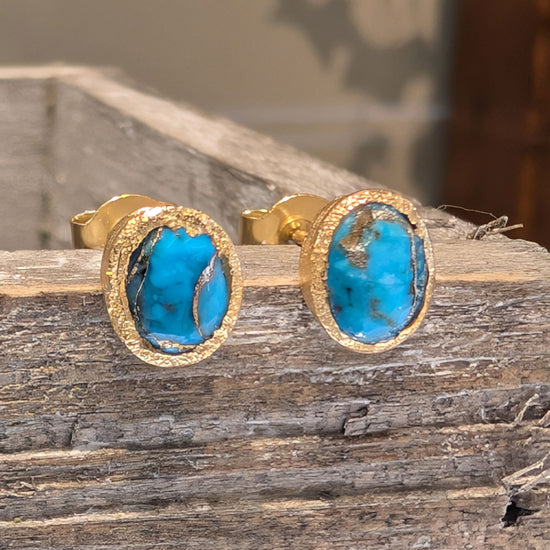 Photo of Birthstone Earrings by Jorge in a decorative scene, designed by -, available at Plumb Gold & Plumb Silver