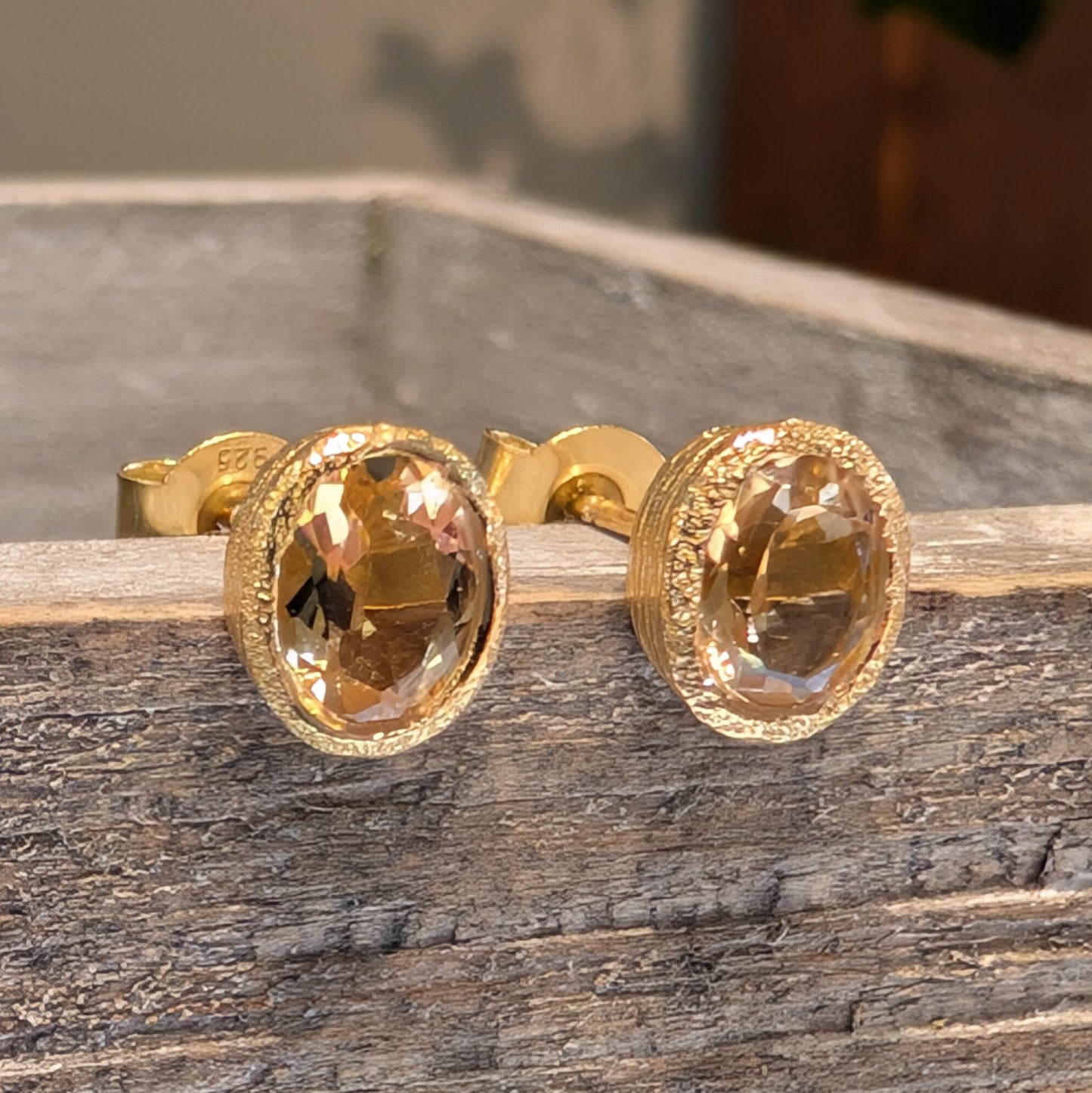 Photo of Birthstone Earrings by Jorge in a decorative scene, designed by -, available at Plumb Gold & Plumb Silver