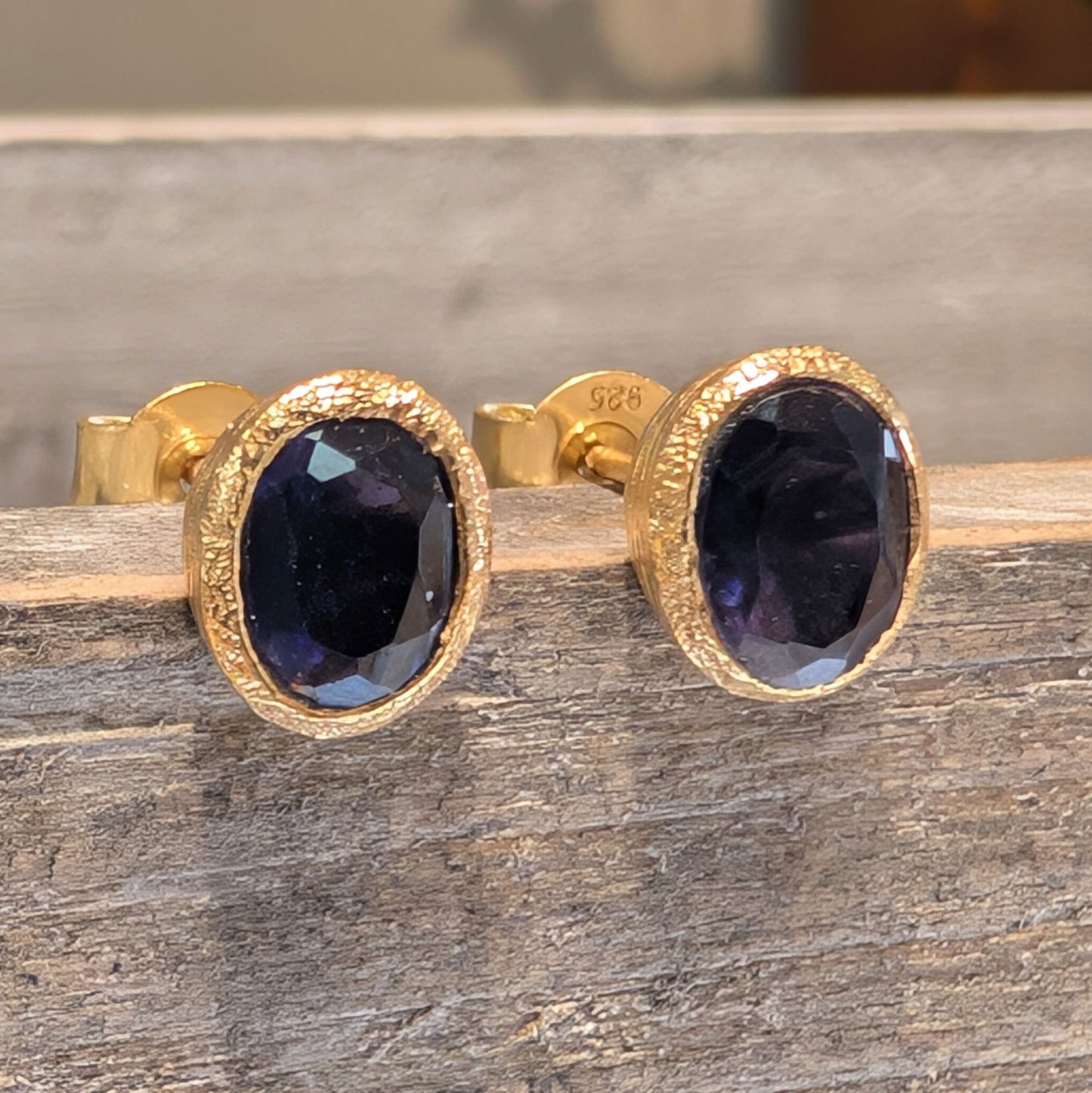 Photo of Birthstone Earrings by Jorge in a decorative scene, designed by -, available at Plumb Gold & Plumb Silver