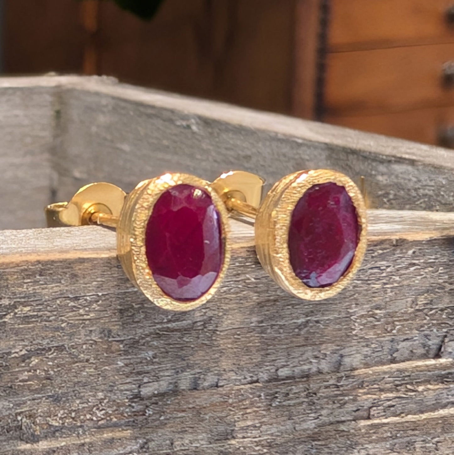 Photo of Birthstone Earrings by Jorge in a decorative scene, designed by -, available at Plumb Gold & Plumb Silver