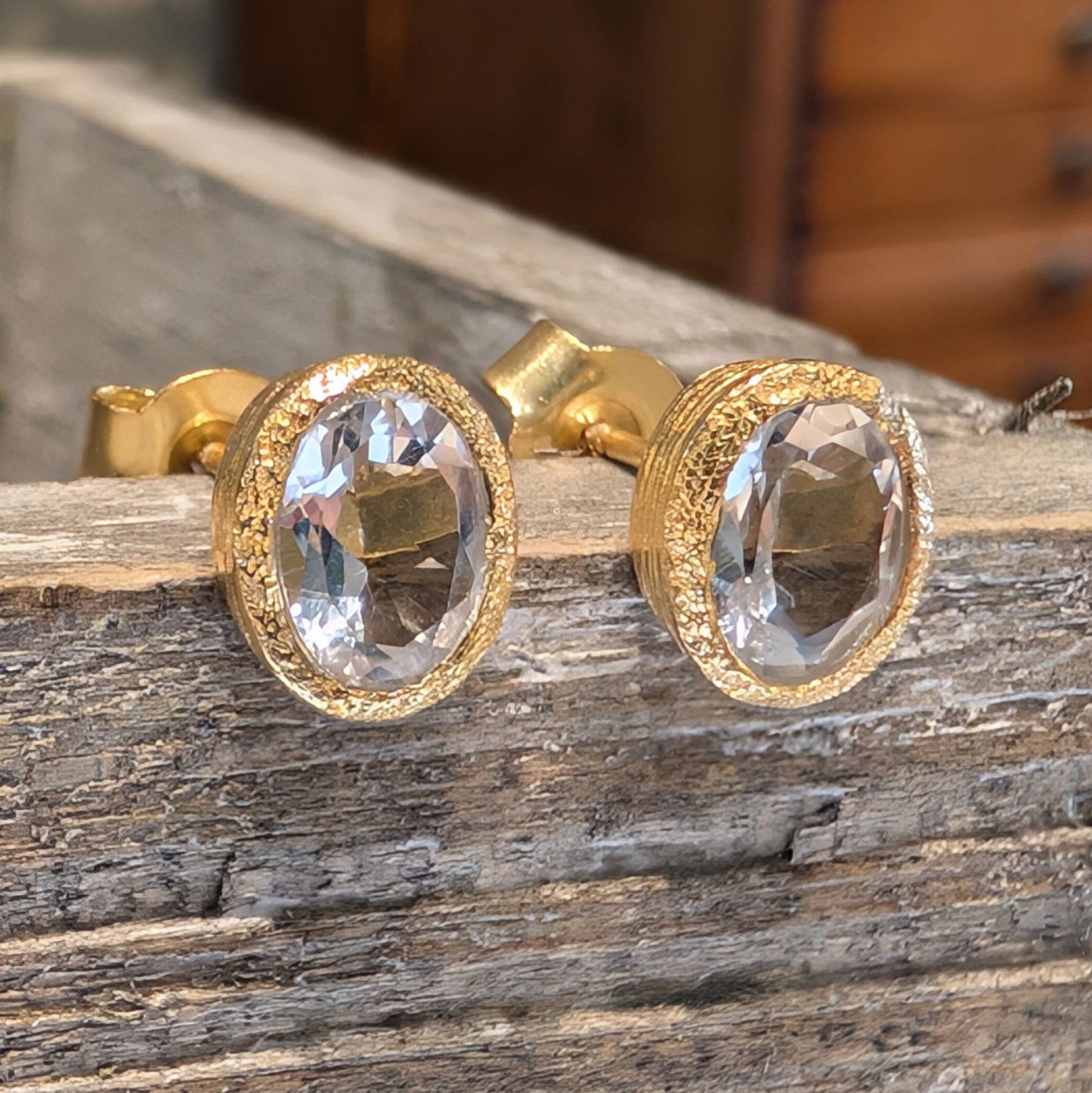 Photo of Birthstone Earrings by Jorge in a decorative scene, designed by -, available at Plumb Gold & Plumb Silver