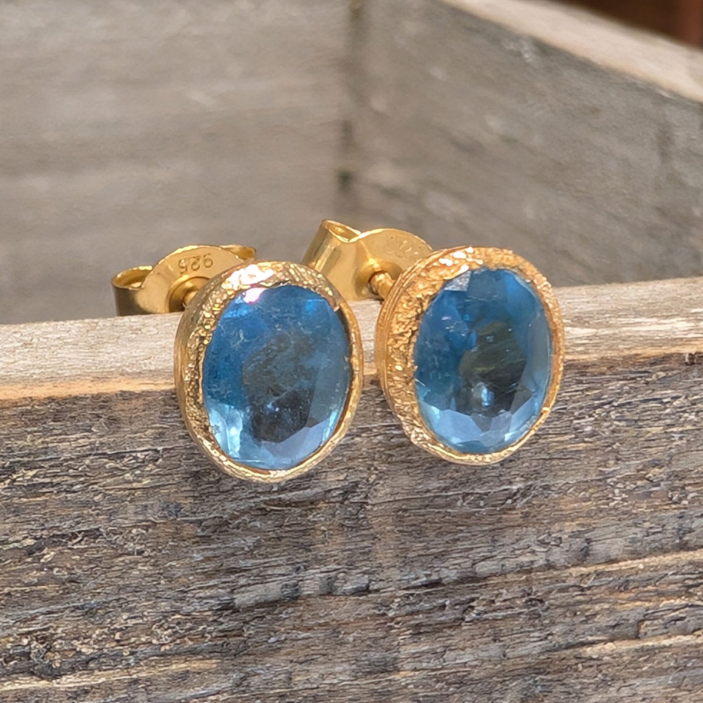 Photo of Birthstone Earrings by Jorge in a decorative scene, designed by -, available at Plumb Gold & Plumb Silver