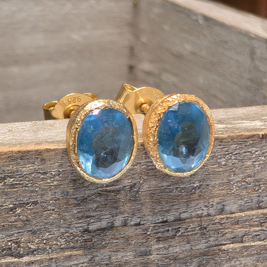 Photo of Birthstone Earrings by Jorge in a decorative scene, designed by -, available at Plumb Gold & Plumb Silver