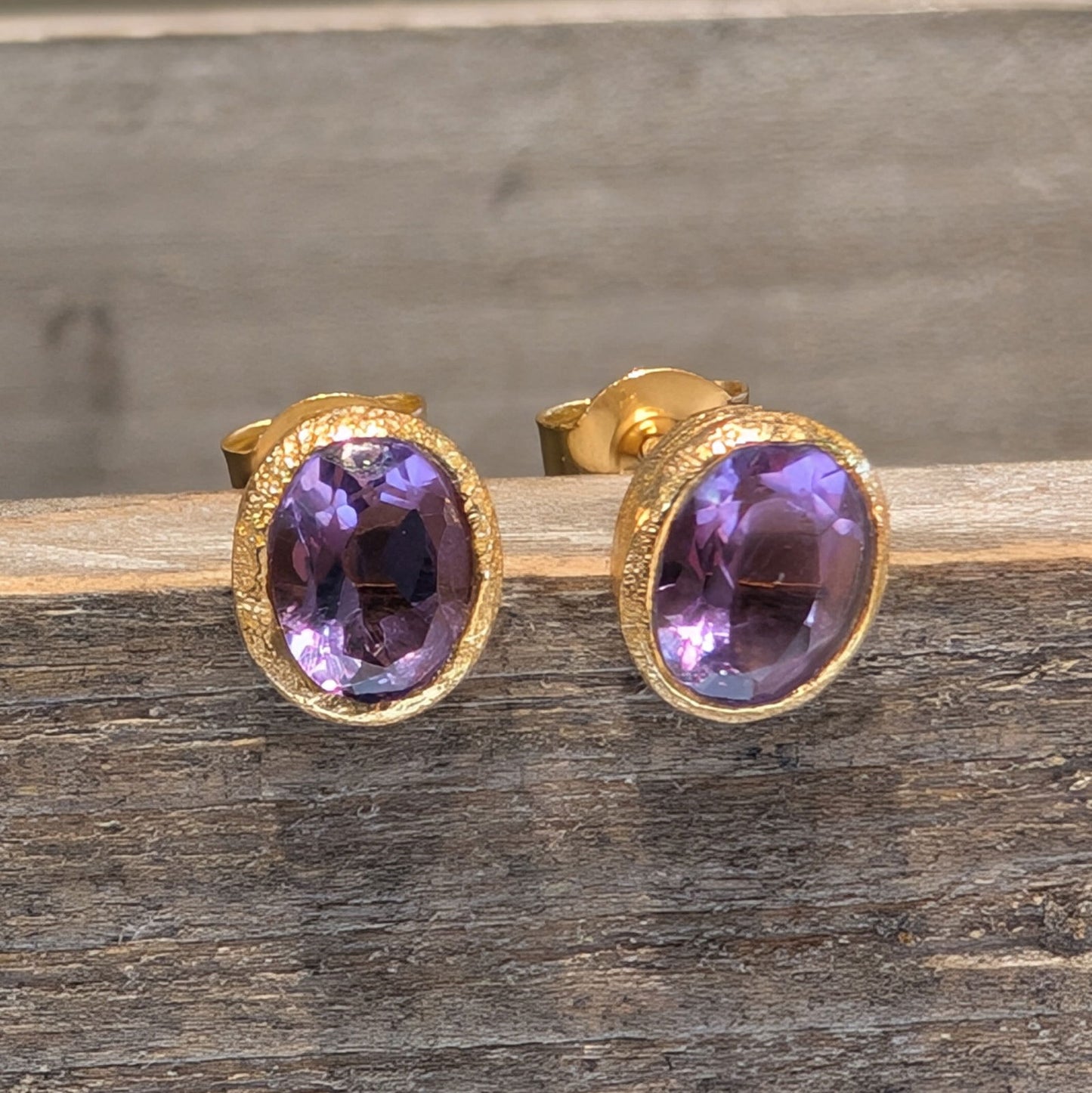 Photo of Birthstone Earrings by Jorge in a decorative scene, designed by -, available at Plumb Gold & Plumb Silver