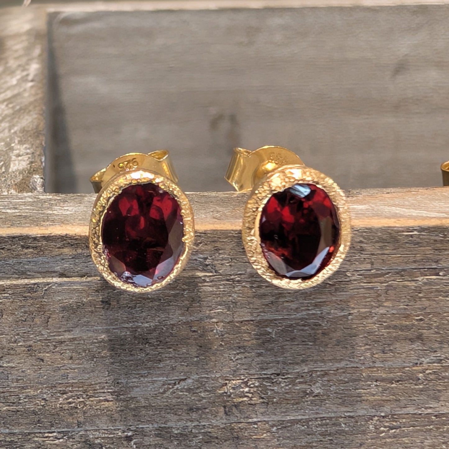 Photo of Birthstone Earrings by Jorge in a decorative scene, designed by -, available at Plumb Gold & Plumb Silver