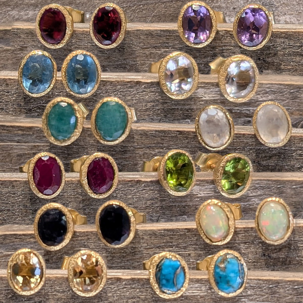 Photo of Birthstone Earrings by Jorge in a decorative scene, designed by -, available at Plumb Gold & Plumb Silver