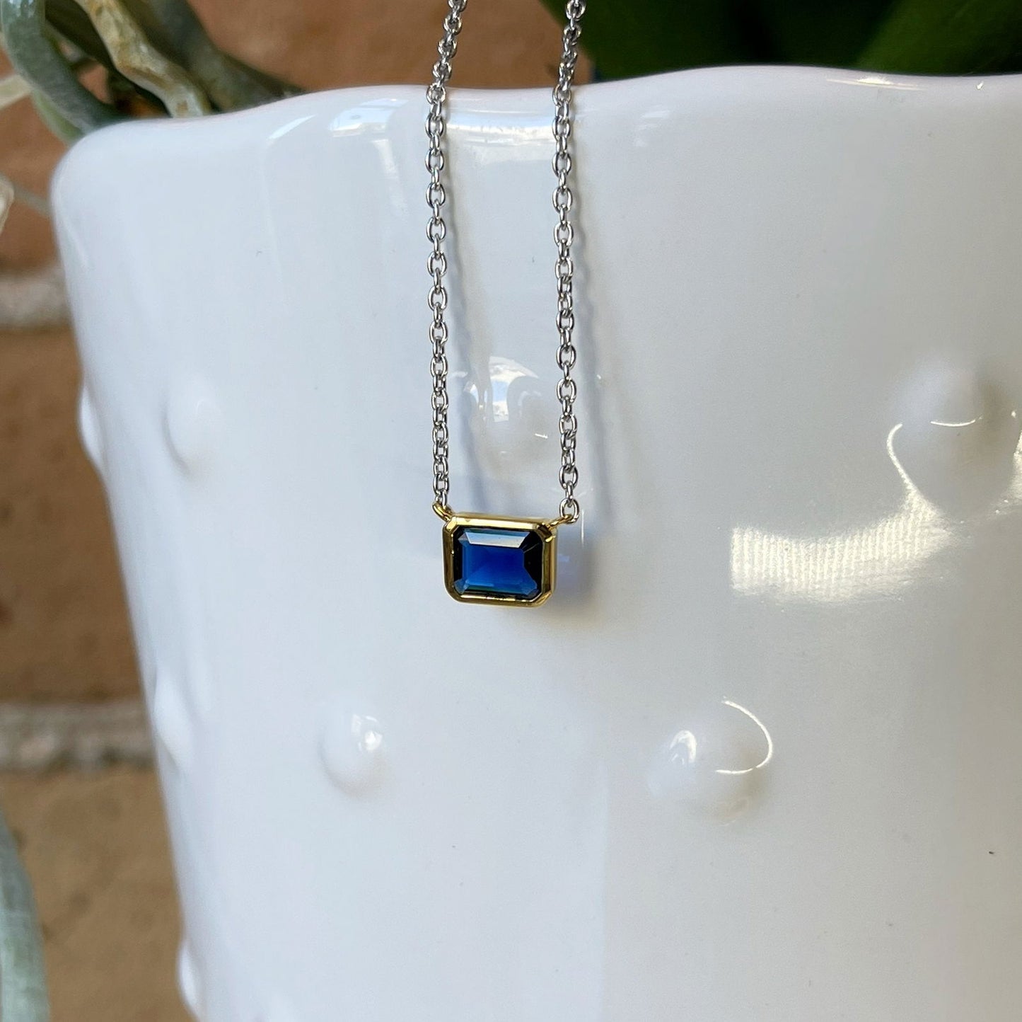 Photo of Blue Cubic Zirconia Necklace in a decorative scene, designed by , available at Plumb Gold & Plumb Silver