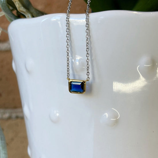 Photo of Blue Cubic Zirconia Necklace in a decorative scene, designed by , available at Plumb Gold & Plumb Silver