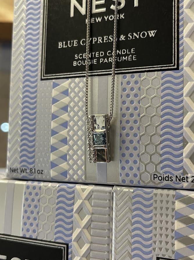 Photo of Blue Diamond Pendant in a decorative scene, designed by , available at Plumb Gold & Plumb Silver