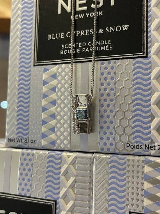 Photo of Blue Diamond Pendant in a decorative scene, designed by , available at Plumb Gold & Plumb Silver