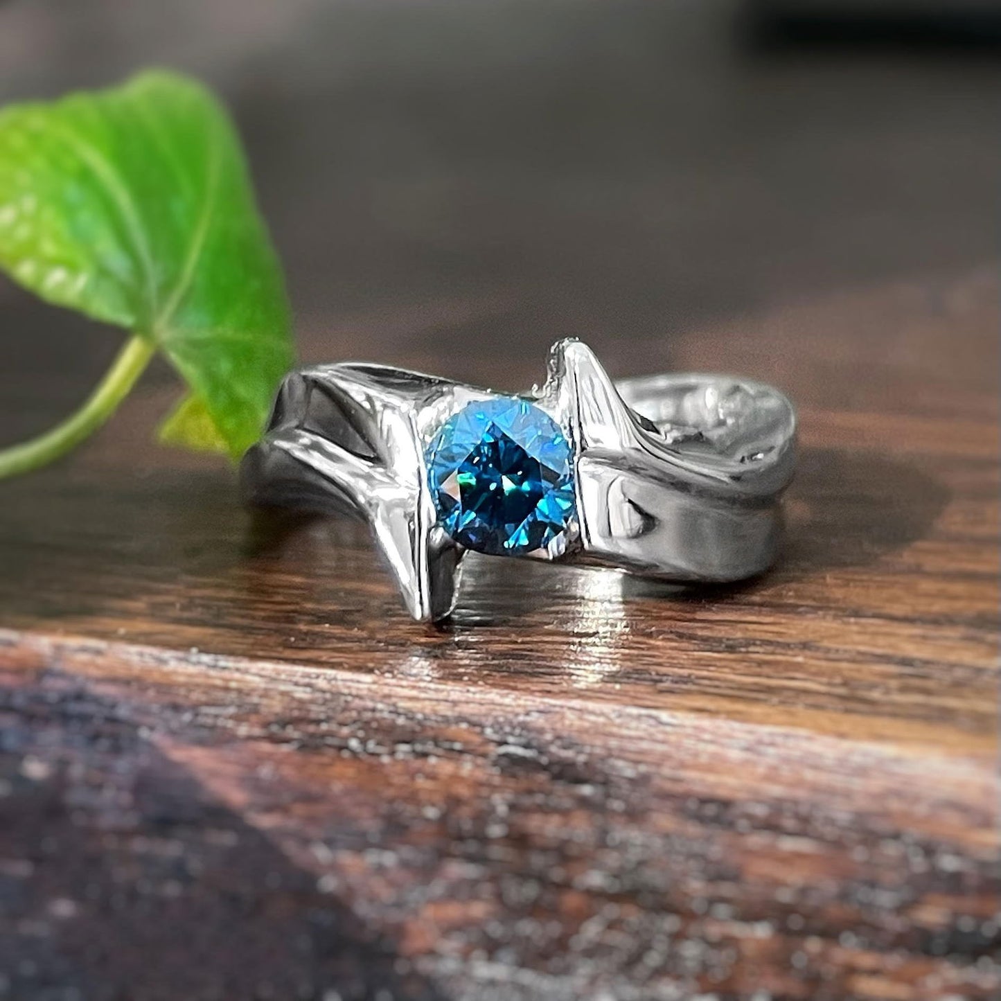 Photo of Blue Diamond Ring in a decorative scene, designed by , available at Plumb Gold & Plumb Silver