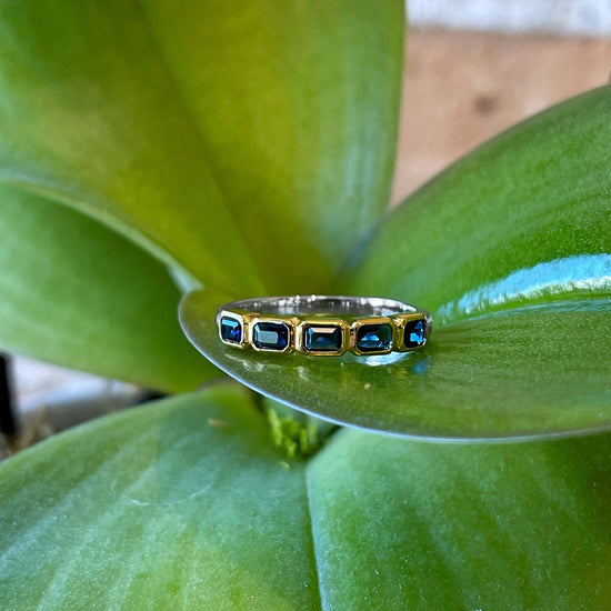 Photo of Blue Emerald-Cut Cubic Zirconia Ring in a decorative scene, designed by , available at Plumb Gold & Plumb Silver