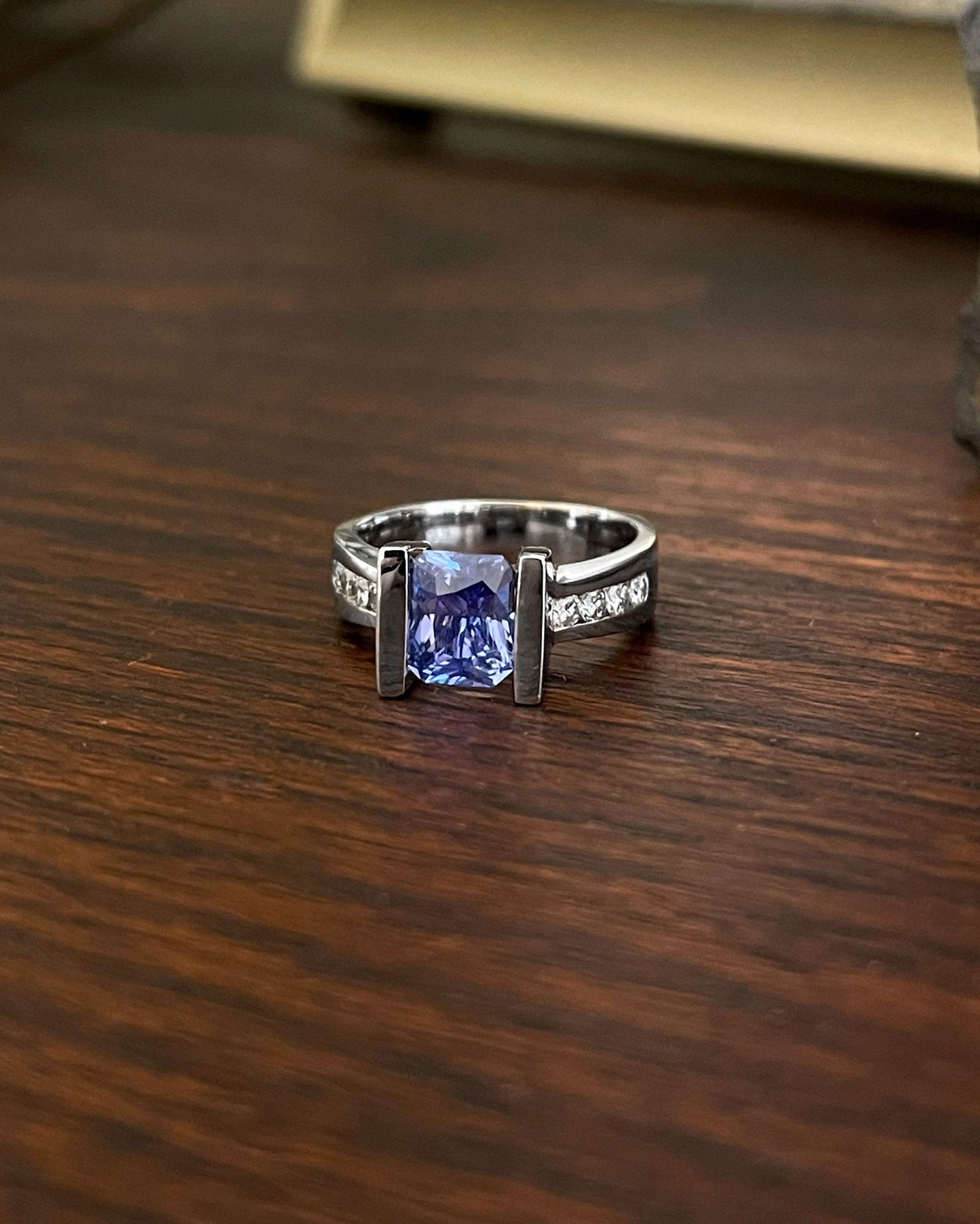 Photo of Blue Sapphire Ring in a decorative scene, designed by , available at Plumb Gold & Plumb Silver