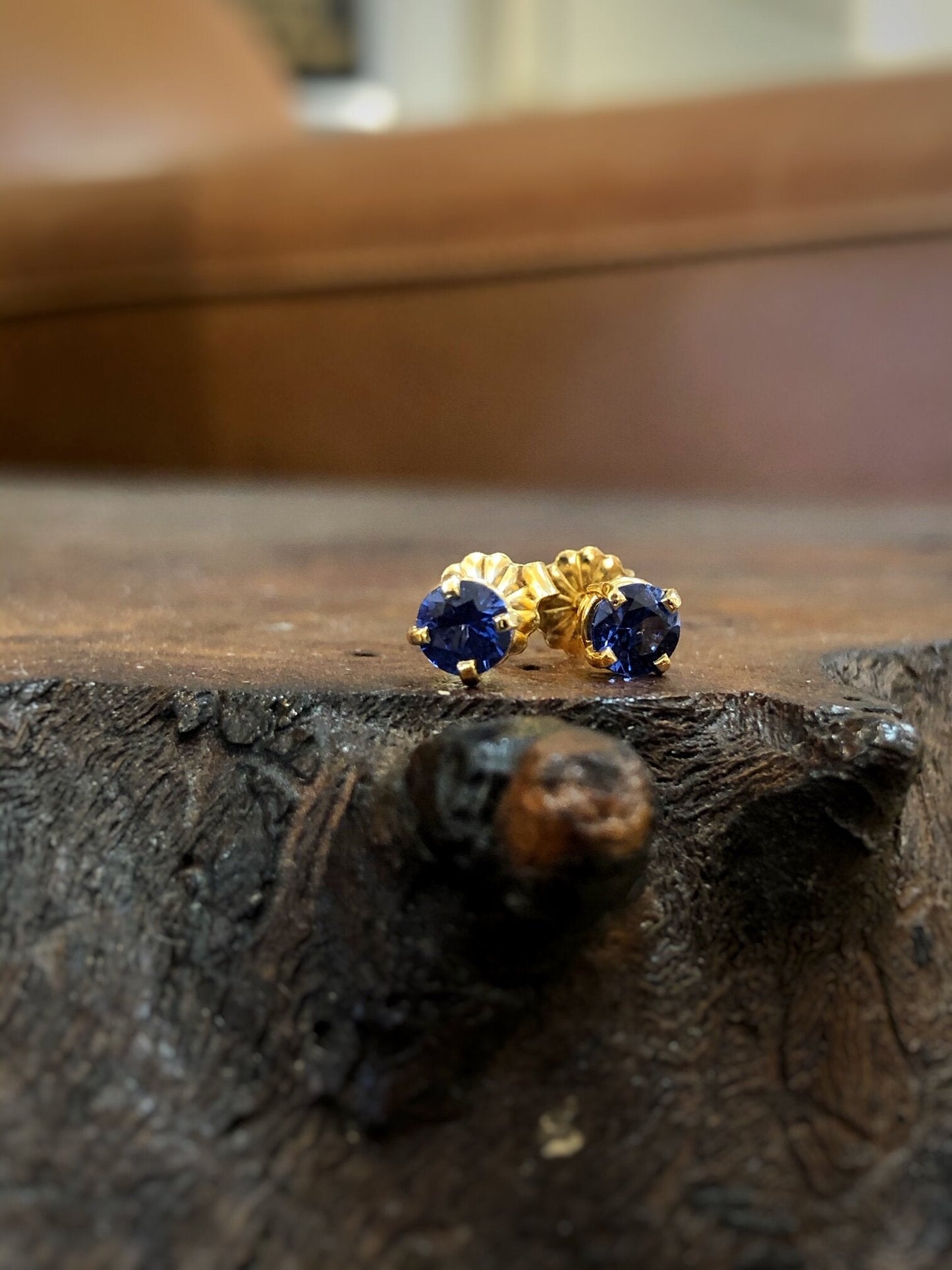 Photo of Blue Sapphire Studs in a decorative scene, designed by , available at Plumb Gold & Plumb Silver