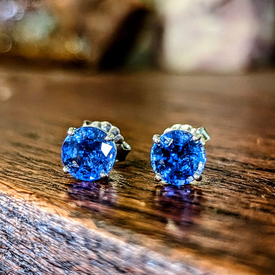 Photo of Blue Sapphire Studs in a decorative scene, designed by , available at Plumb Gold & Plumb Silver