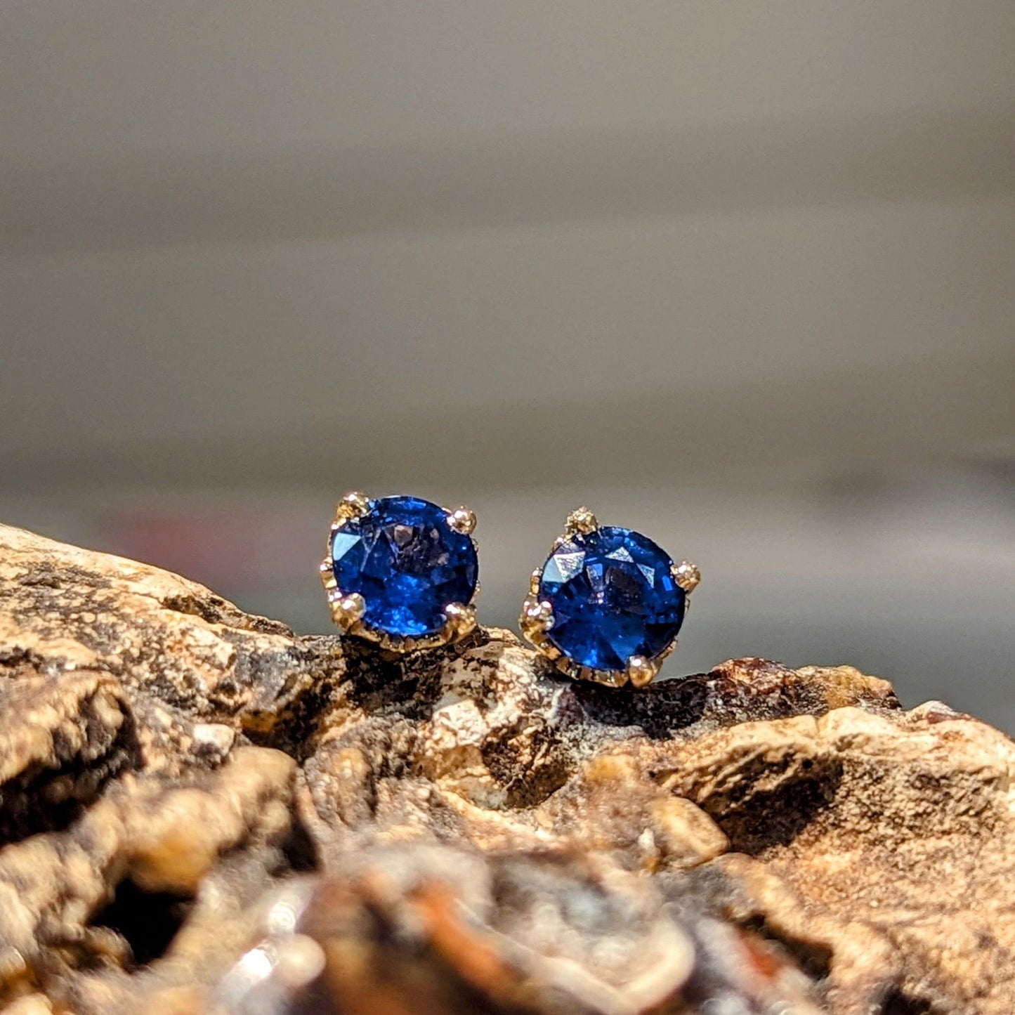 Photo of Blue Sapphire Studs in a decorative scene, designed by , available at Plumb Gold & Plumb Silver