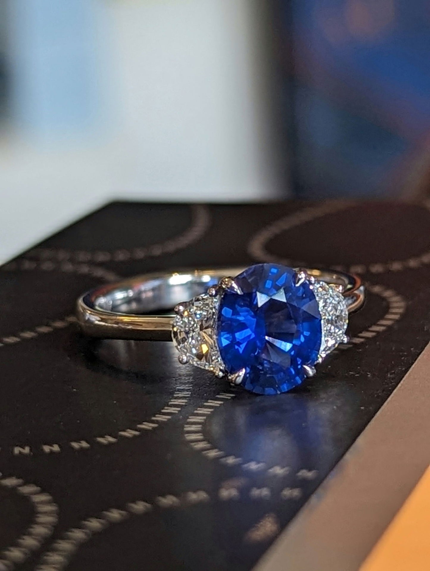 Photo of Blue Sapphire and Diamond Ring in a decorative scene, designed by , available at Plumb Gold & Plumb Silver