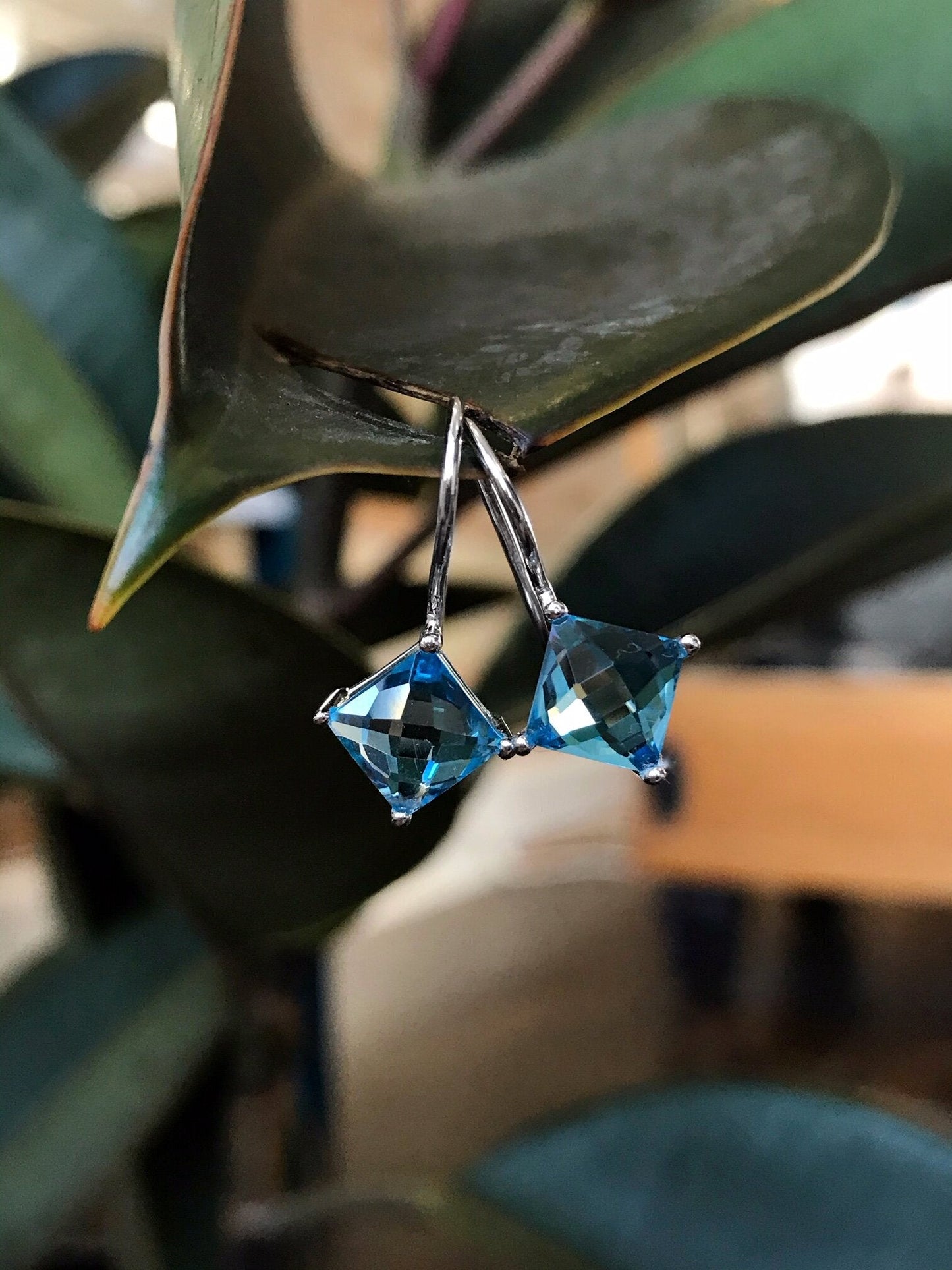 Photo of Blue Topaz Dangles in a decorative scene, designed by , available at Plumb Gold & Plumb Silver
