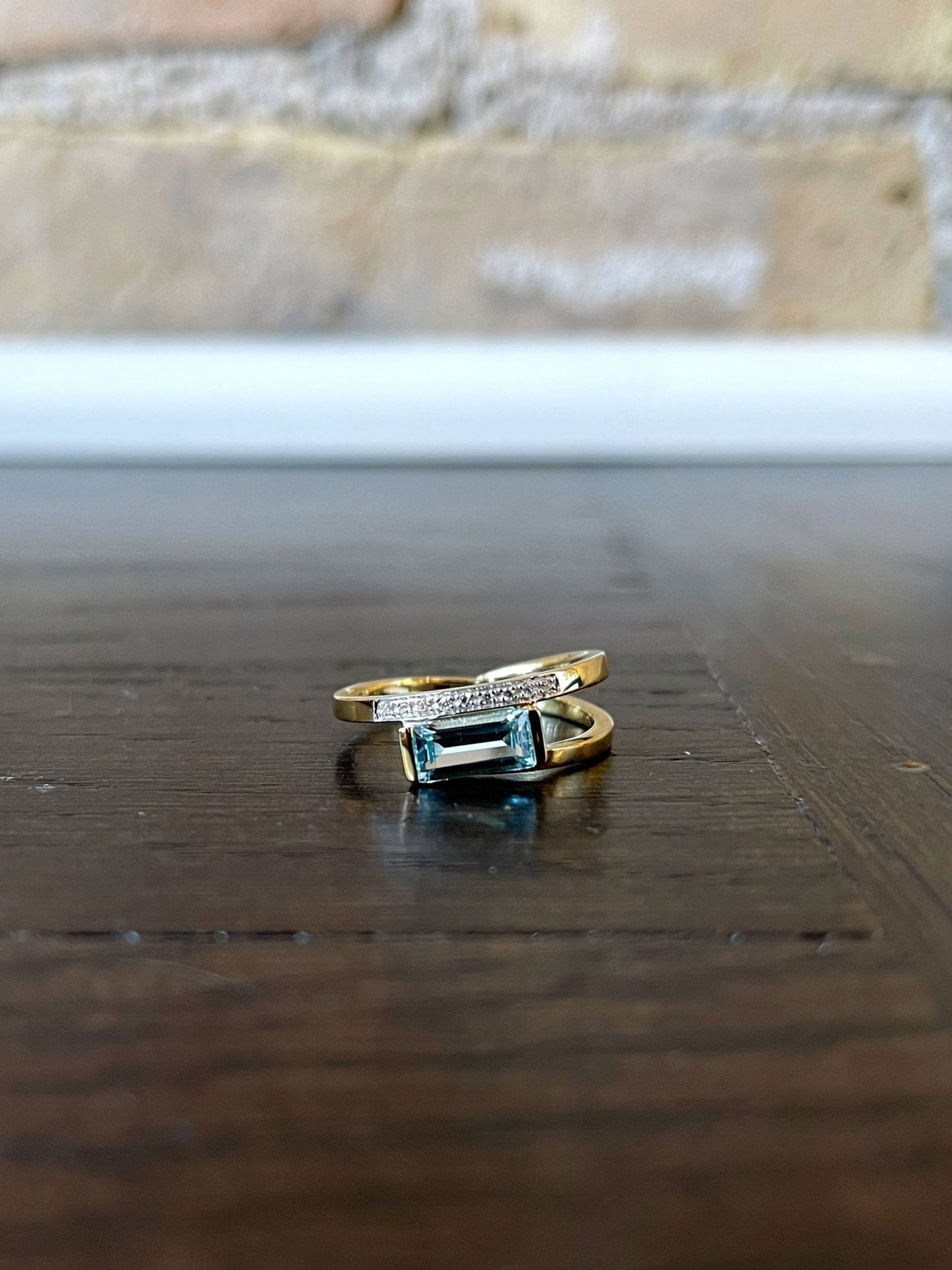 Photo of Blue Topaz and Diamond Ring in a decorative scene, designed by , available at Plumb Gold & Plumb Silver