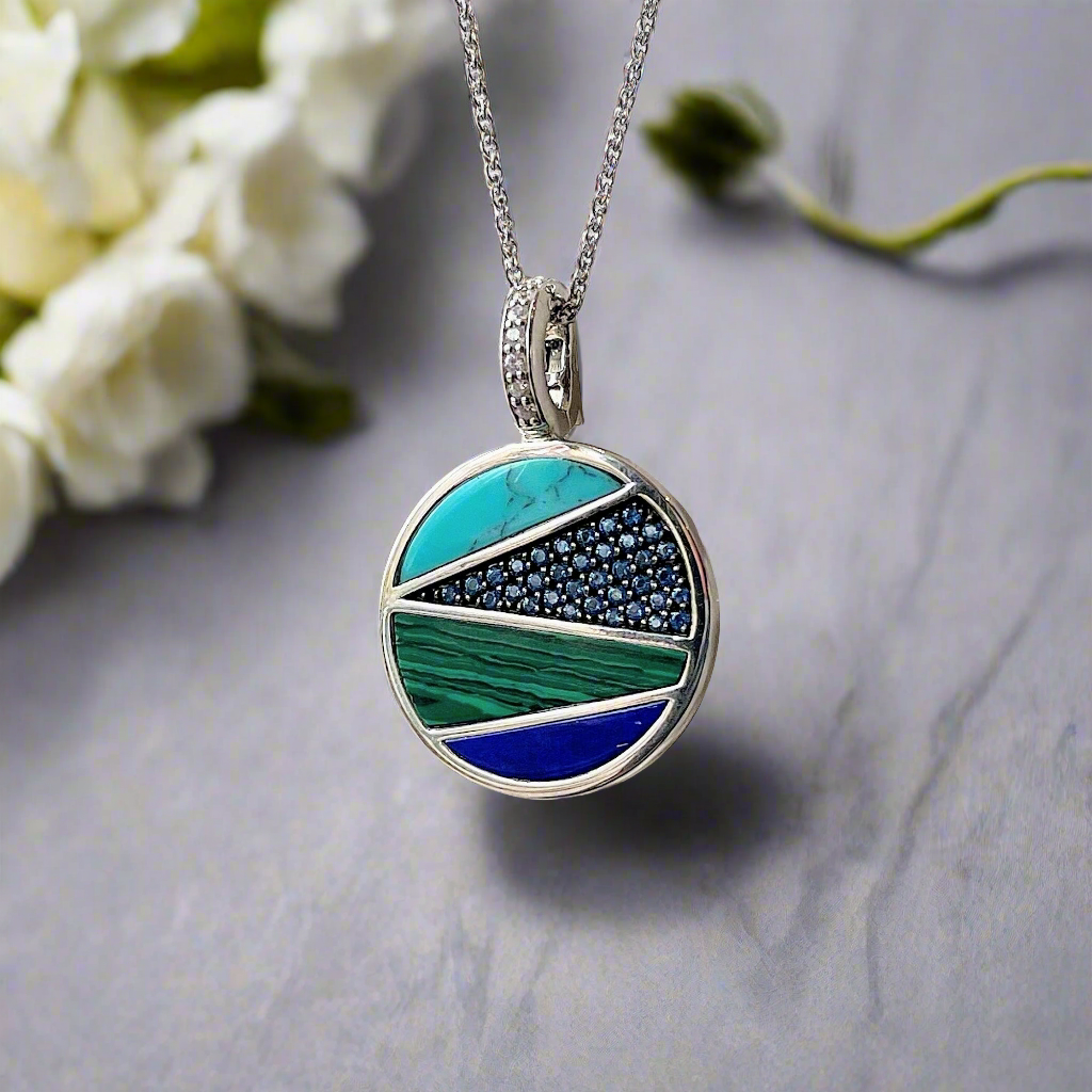 Photo of Blue and Green Inlay Necklace in a decorative scene, designed by , available at Plumb Gold & Plumb Silver