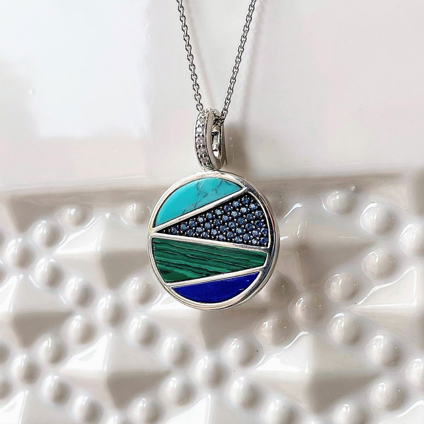 Photo of Blue and Green Inlay Necklace in a decorative scene, designed by , available at Plumb Gold & Plumb Silver